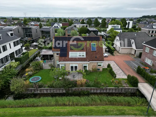 Woning met zonnepanelen in een woonwijk, van bovenaf